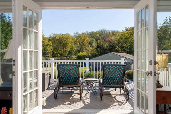 a view of a chair and table in the balcony
