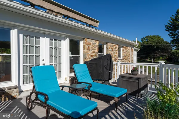 a balcony with furniture and umbrella
