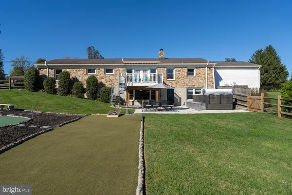 a view of a house with backyard porch and sitting area