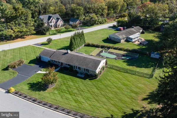 an aerial view of a house with a garden and lake view