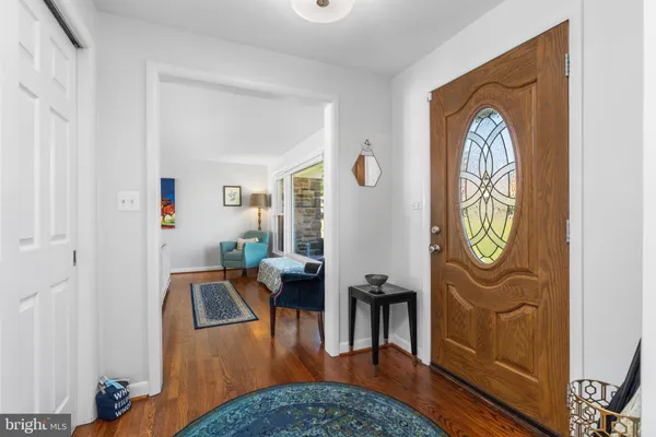 a living room with furniture a table and wooden floor