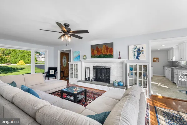 a living room with furniture fireplace and a large window
