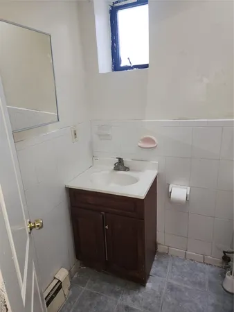 a bathroom with a sink vanity and a mirror