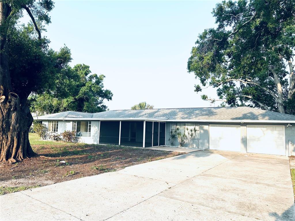 4634 McIntosh Road Sarasota, FL 34233 - Photo 2 of 20 a view of house with outdoor space and sitting area