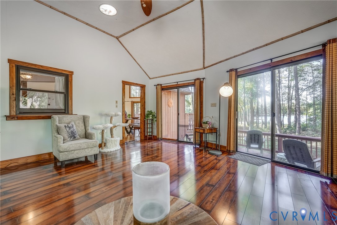 7399 Club Drive Quinton, VA 23141 - Photo 16 of 42 a living room with furniture large wooden floor and floor to ceiling windows