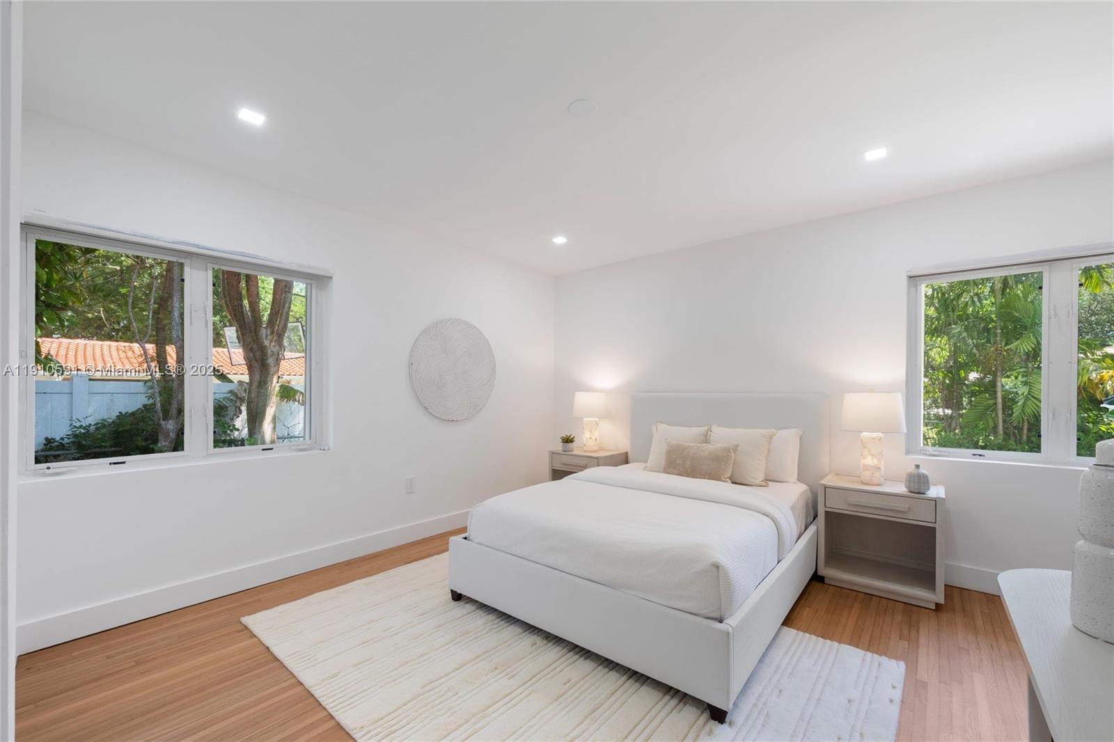 5211 Granada Boulevard Coral Gables, FL 33146 - Photo 19 of 25 a bedroom with a large bed and a large window