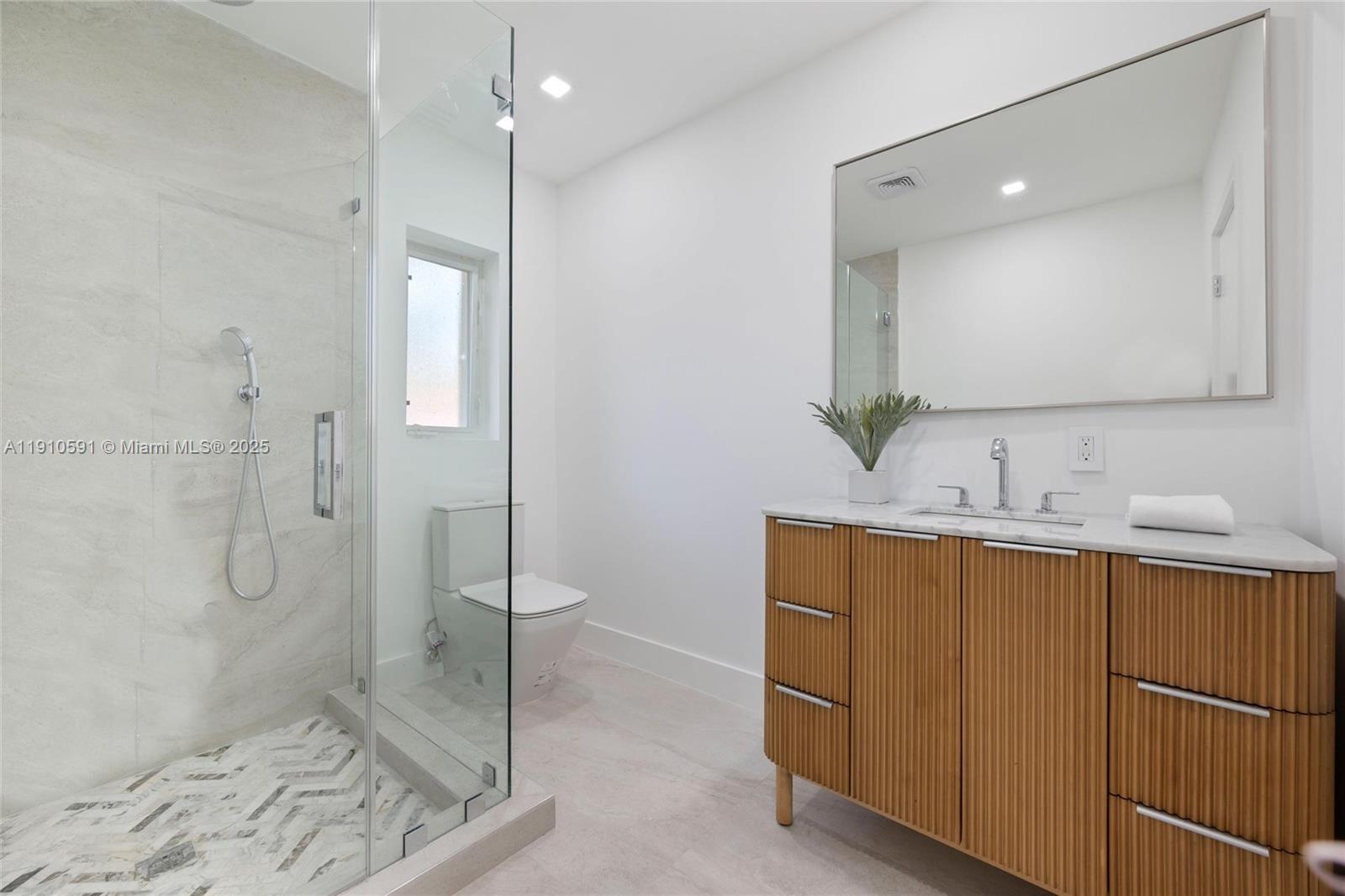 5211 Granada Boulevard Coral Gables, FL 33146 - Photo 21 of 25 a bathroom with a double vanity sink mirror and shower