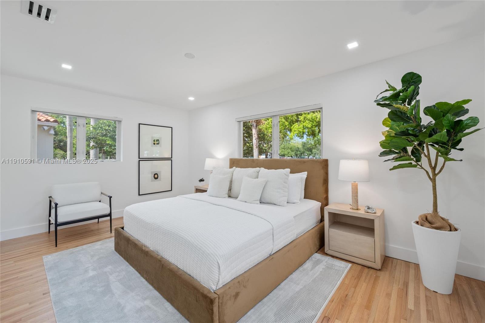 5211 Granada Boulevard Coral Gables, FL 33146 - Photo 22 of 25 a bedroom with a large bed and a potted plant