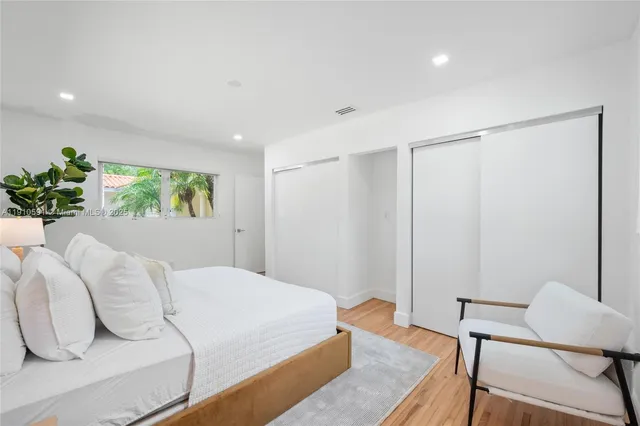 a bedroom with a bed and a chair