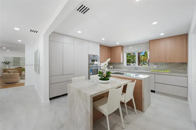 a kitchen with kitchen island granite countertop wooden cabinets and counter space