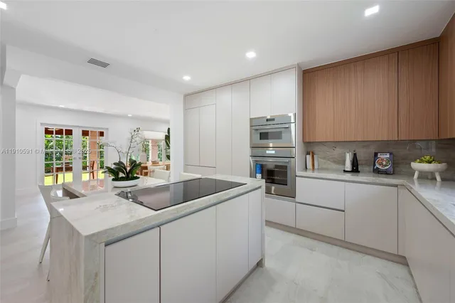 a kitchen with stainless steel appliances granite countertop a sink and cabinets