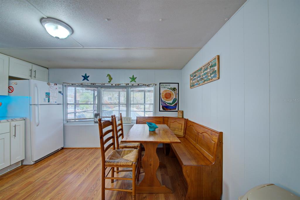 6427 West Richard Drive Weeki Wachee, FL 34607 - Photo 10 of 35 a view of a dining room with furniture and wooden floor