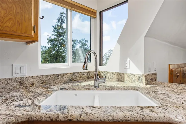 a view of a kitchen sink and a window