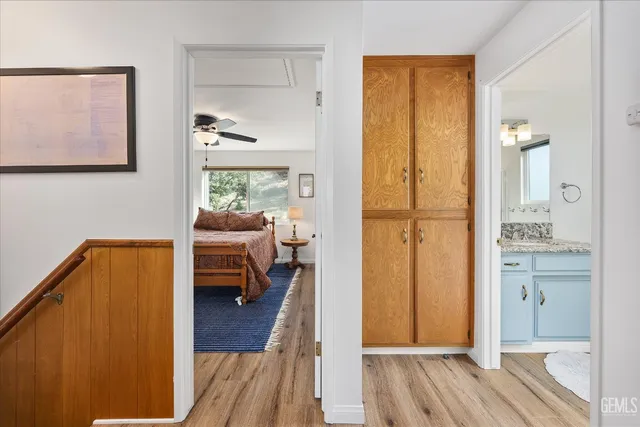 a en suite bathroom with a granite countertop sink and a mirror