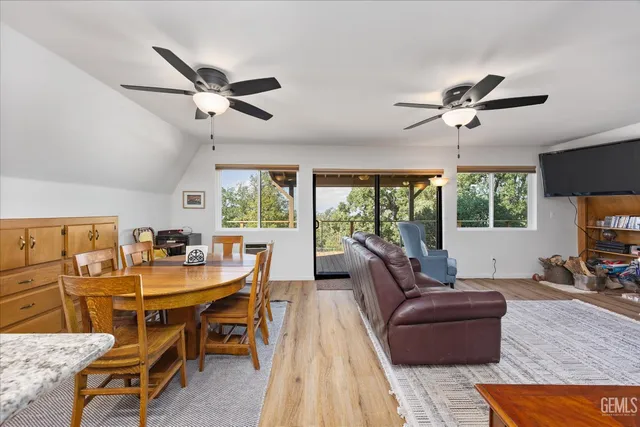 a living room with furniture a flat screen tv and a large window