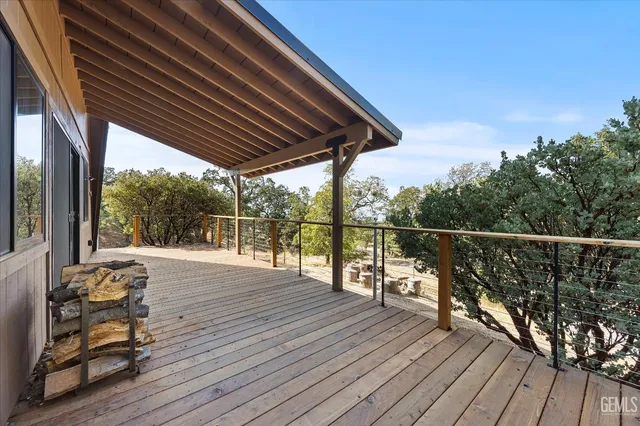 a view of roof deck with wooden floor and seating space