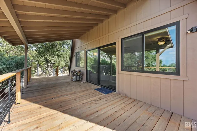 a view of backyard with a deck and wooden floor