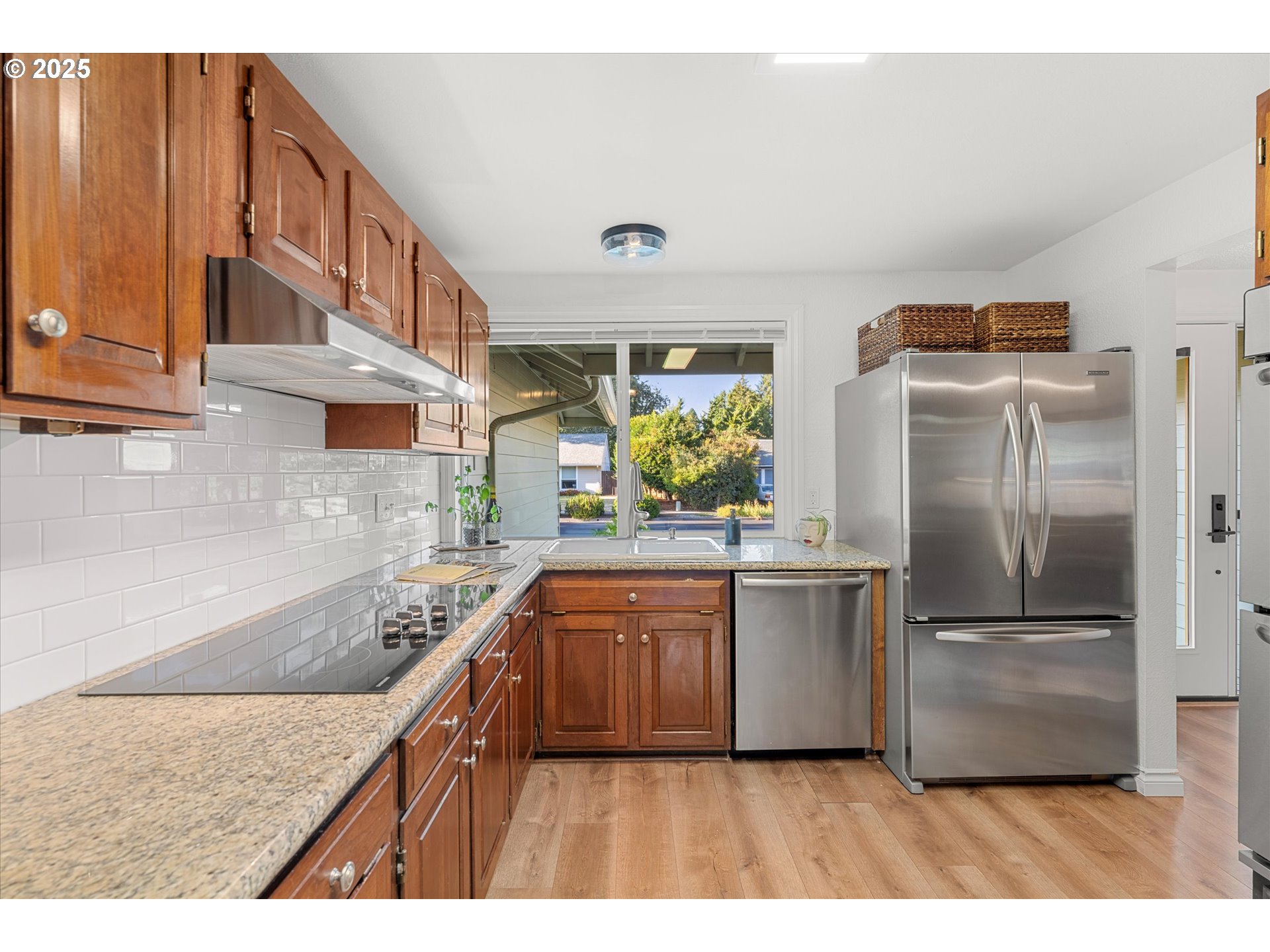 20070 Southwest Imperial Street Beaverton, OR 97003 - Photo 22 of 48 a kitchen with stainless steel appliances granite countertop a kitchen island a stove a refrigerator and a sink