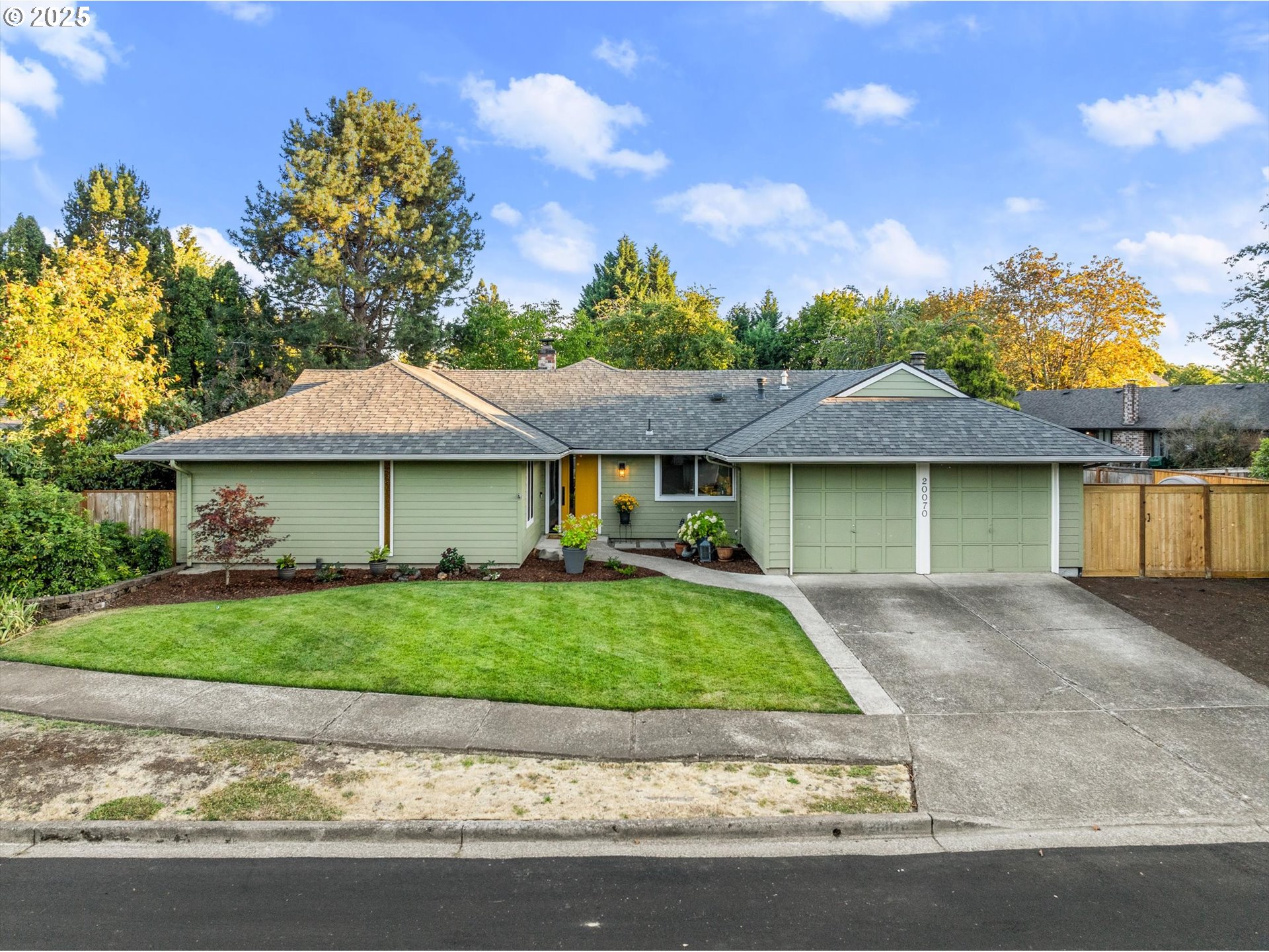 20070 Southwest Imperial Street Beaverton, OR 97003 - Photo 4 of 48 a front view of a house with a garden and plants