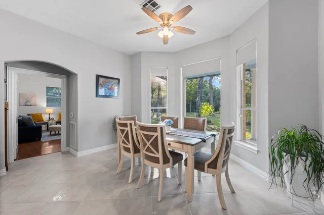 a view of a dining room with furniture a chandelier and wooden floor