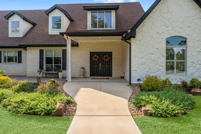 a front view of a house with garden