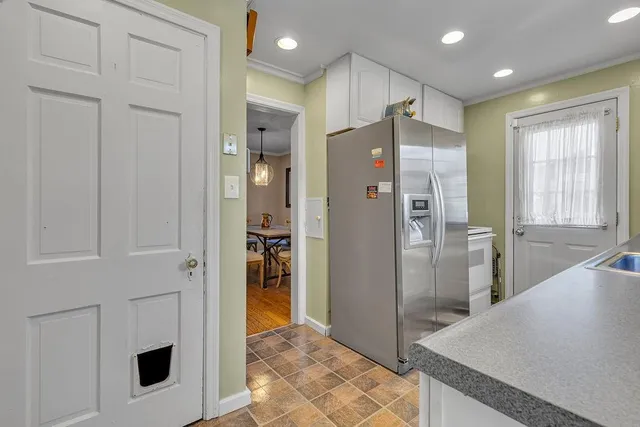 a view of a kitchen with a sink and refrigerator in kitchen
