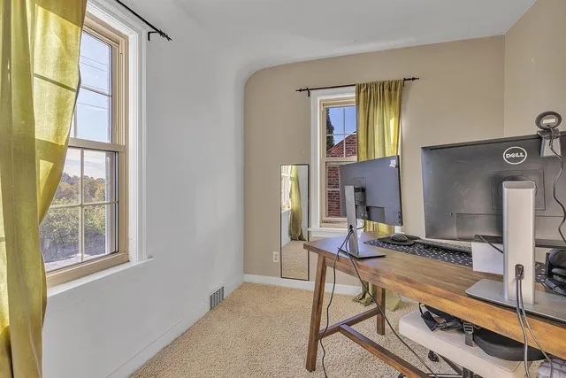 a view of a workspace with furniture