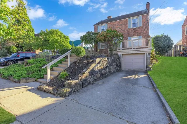 a view of a house with a yard and a garden
