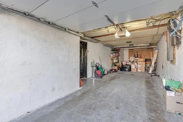 an aerial view of residential houses with outdoor space and trees