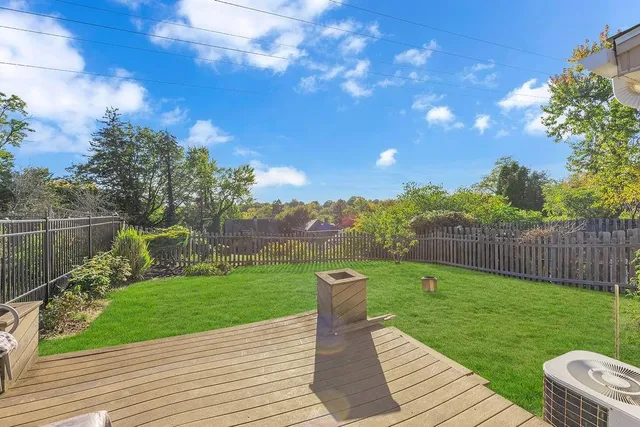 a view of a garden with wooden fence