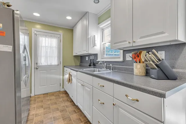 a kitchen with stainless steel appliances granite countertop a sink and cabinets
