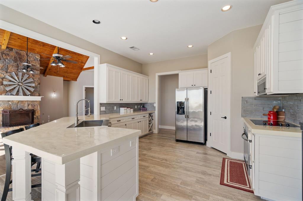 1943 Alsdorf Road Ennis, TX 75119 - Photo 12 of 39 a kitchen that has a lot of cabinets a sink and appliances in it