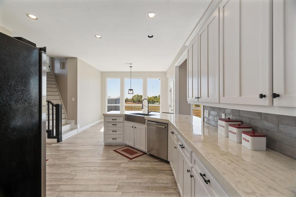 1943 Alsdorf Road Ennis, TX 75119 - Photo 14 of 39 a kitchen with white cabinets and stainless steel appliances