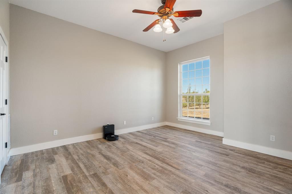 1943 Alsdorf Road Ennis, TX 75119 - Photo 15 of 39 wooden floor in an empty room with a window