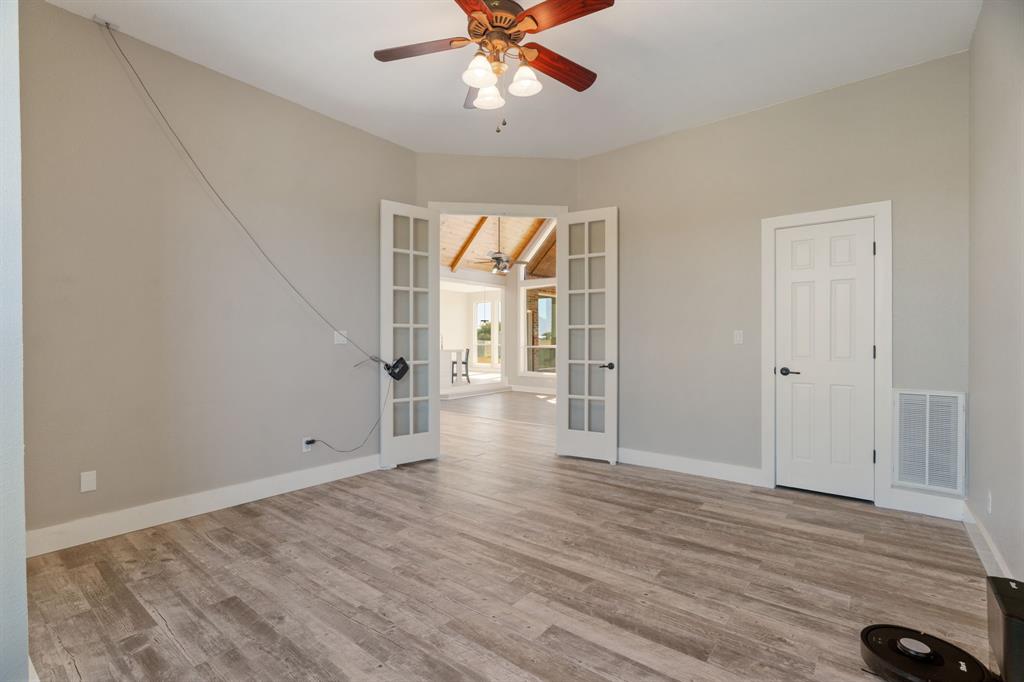 1943 Alsdorf Road Ennis, TX 75119 - Photo 16 of 39 wooden floor in an empty room with a window