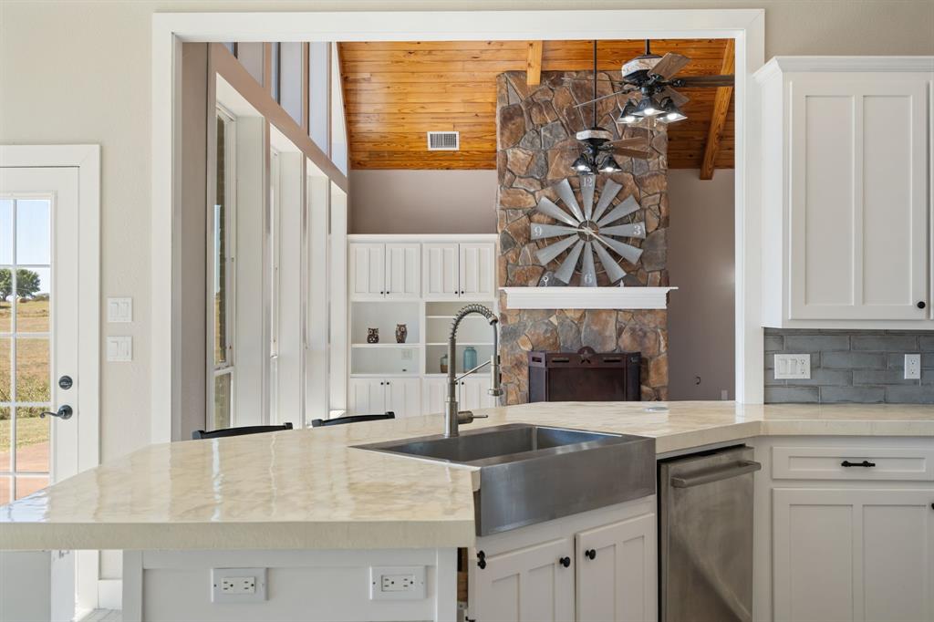 1943 Alsdorf Road Ennis, TX 75119 - Photo 30 of 39 a kitchen with stainless steel appliances granite countertop a stove and a microwave