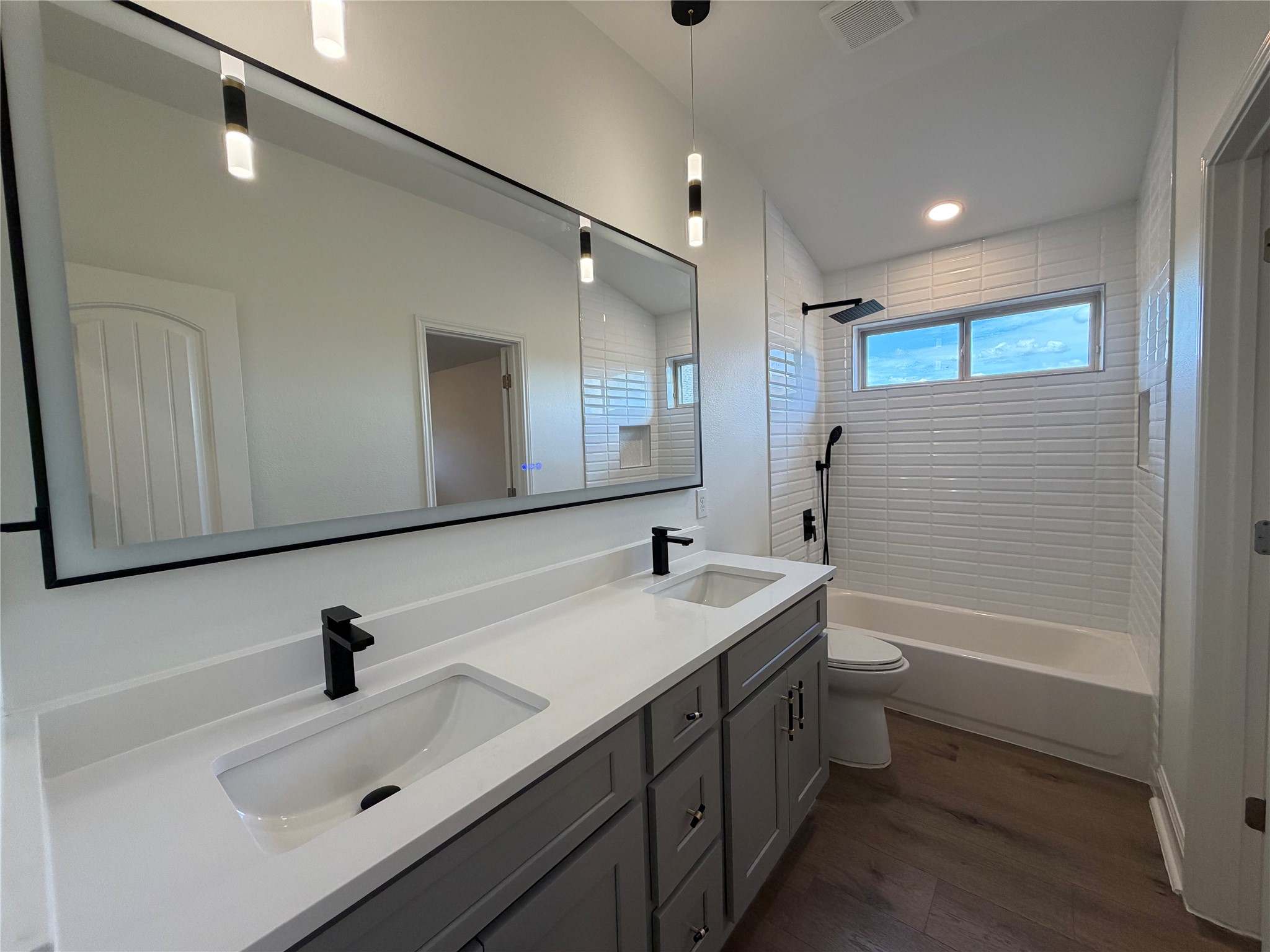 7801 Aria Loop Austin, TX 78736 - Photo 32 of 40 The 2nd bathroom includes a double vanity, shower/tub combination, and lighted mirror
