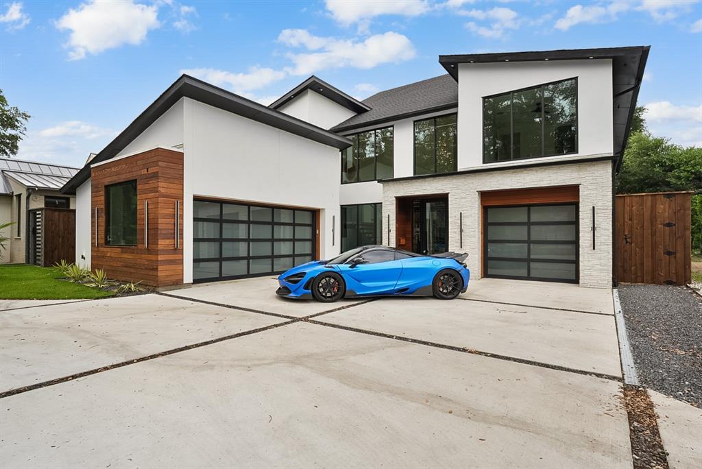 9457 Waterview Road Dallas, TX 75218 - Photo 1 of 28 Modern exterior architecture featuring white stucco, horizontal wood paneling, and stacked stone accents