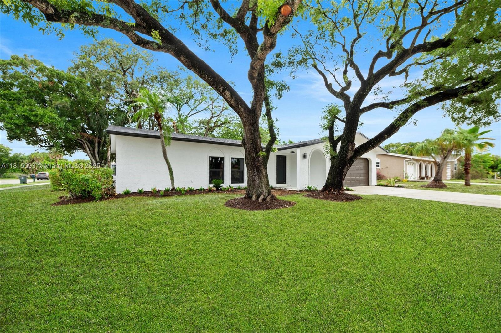 679 Southwest 17th Court Boca Raton, FL 33486 - Photo 18 of 18 a view of a house with backyard and a tree