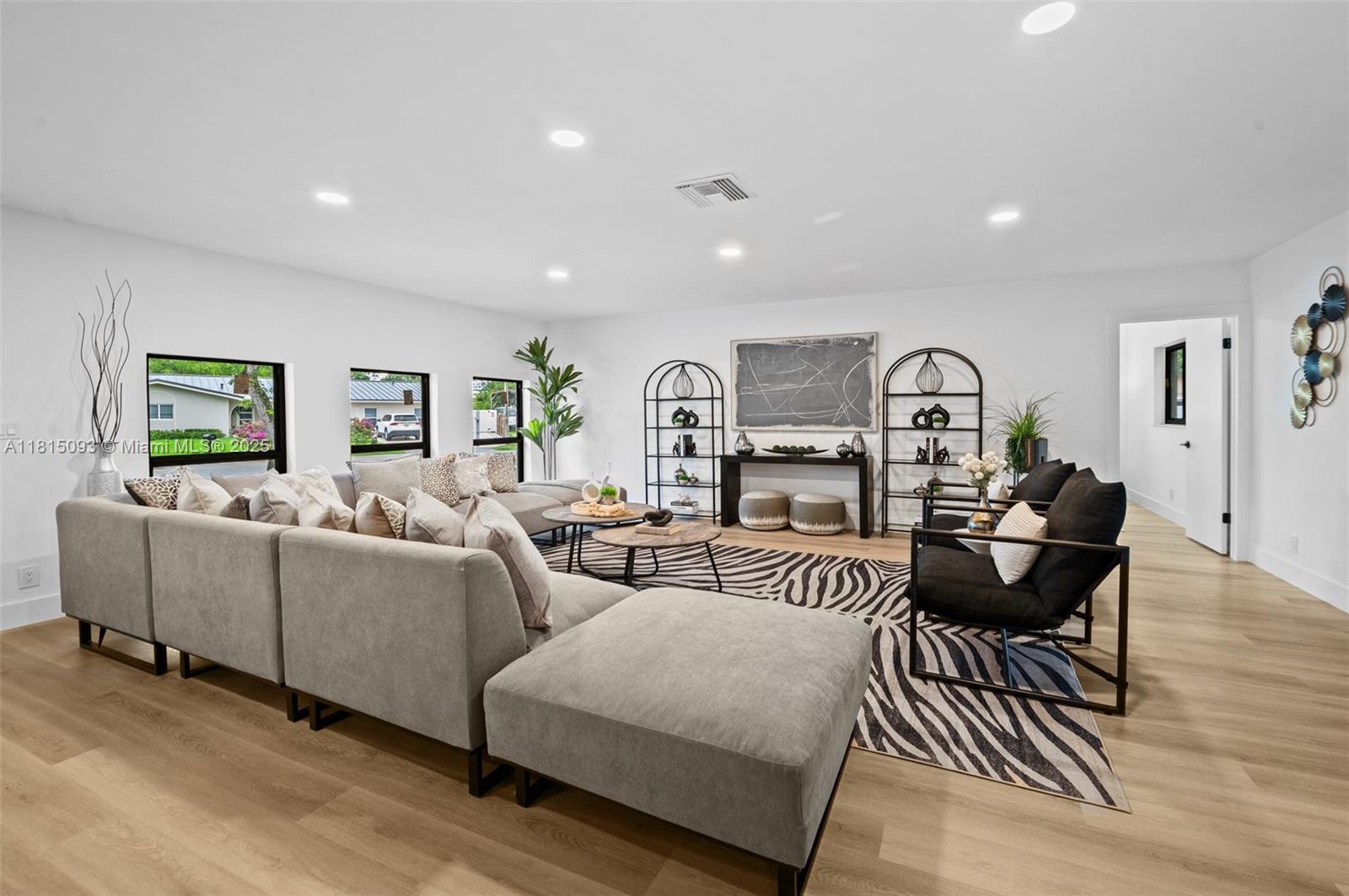 679 Southwest 17th Court Boca Raton, FL 33486 - Photo 2 of 18 a living room with furniture and a table