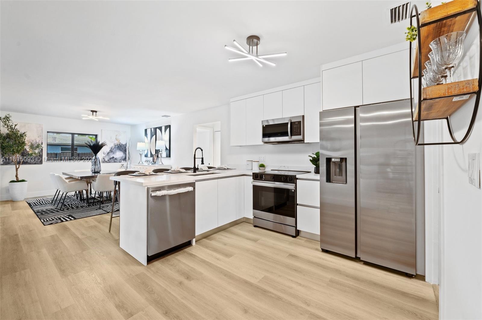 679 Southwest 17th Court Boca Raton, FL 33486 - Photo 7 of 18 a kitchen with cabinets stainless steel appliances and a window