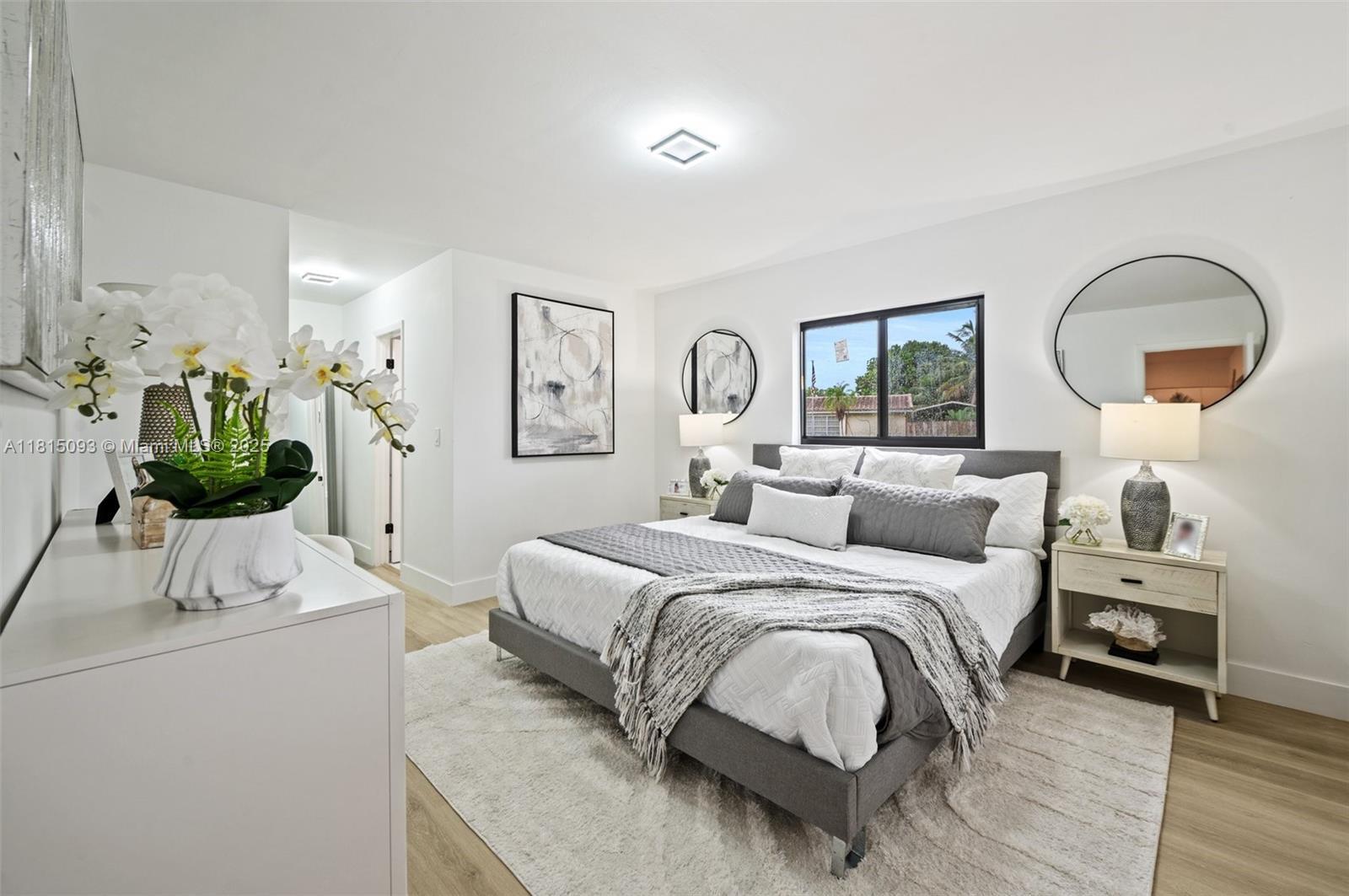 679 Southwest 17th Court Boca Raton, FL 33486 - Photo 10 of 18 a bedroom with a bed and a potted plant