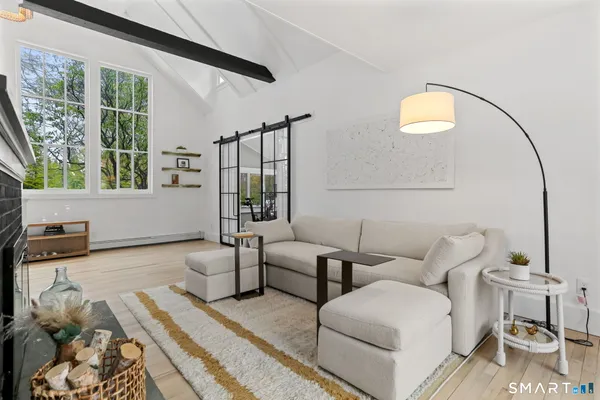 a living room with furniture and a floor to ceiling window
