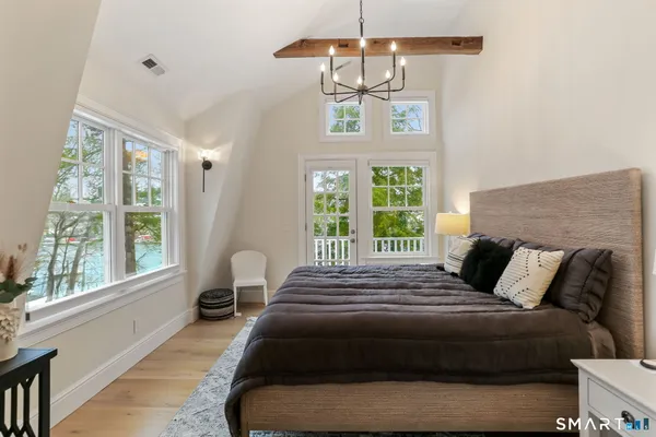a bedroom with a bed and a chandelier