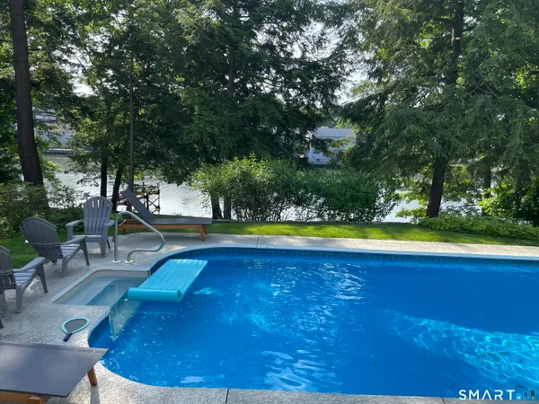 a view of a swimming pool with an outdoor space and seating area