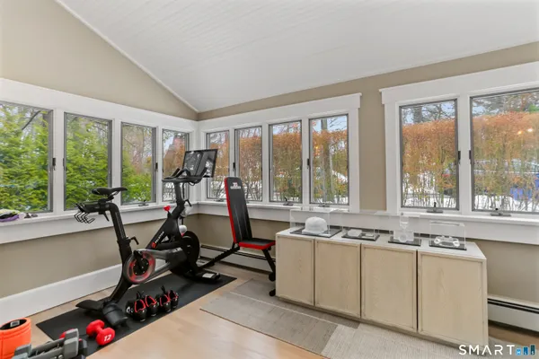 a view of a room with gym equipment and a large window