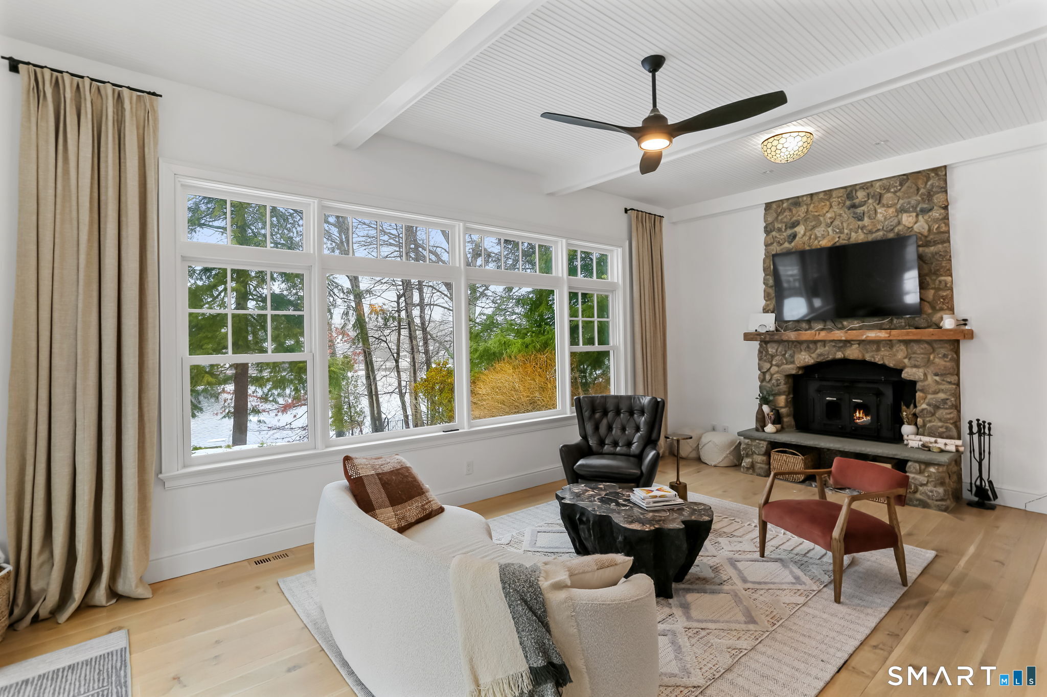 3 Riverview Road Westport, CT 06880 - Photo 9 of 29 a living room with furniture a fireplace and a flat screen tv