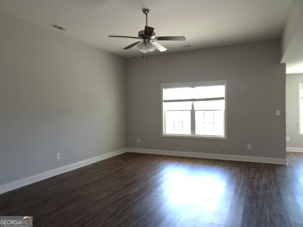 133 Worchester Circle Perry, GA 31069 - Photo 6 of 16 an empty room with wooden floor and windows