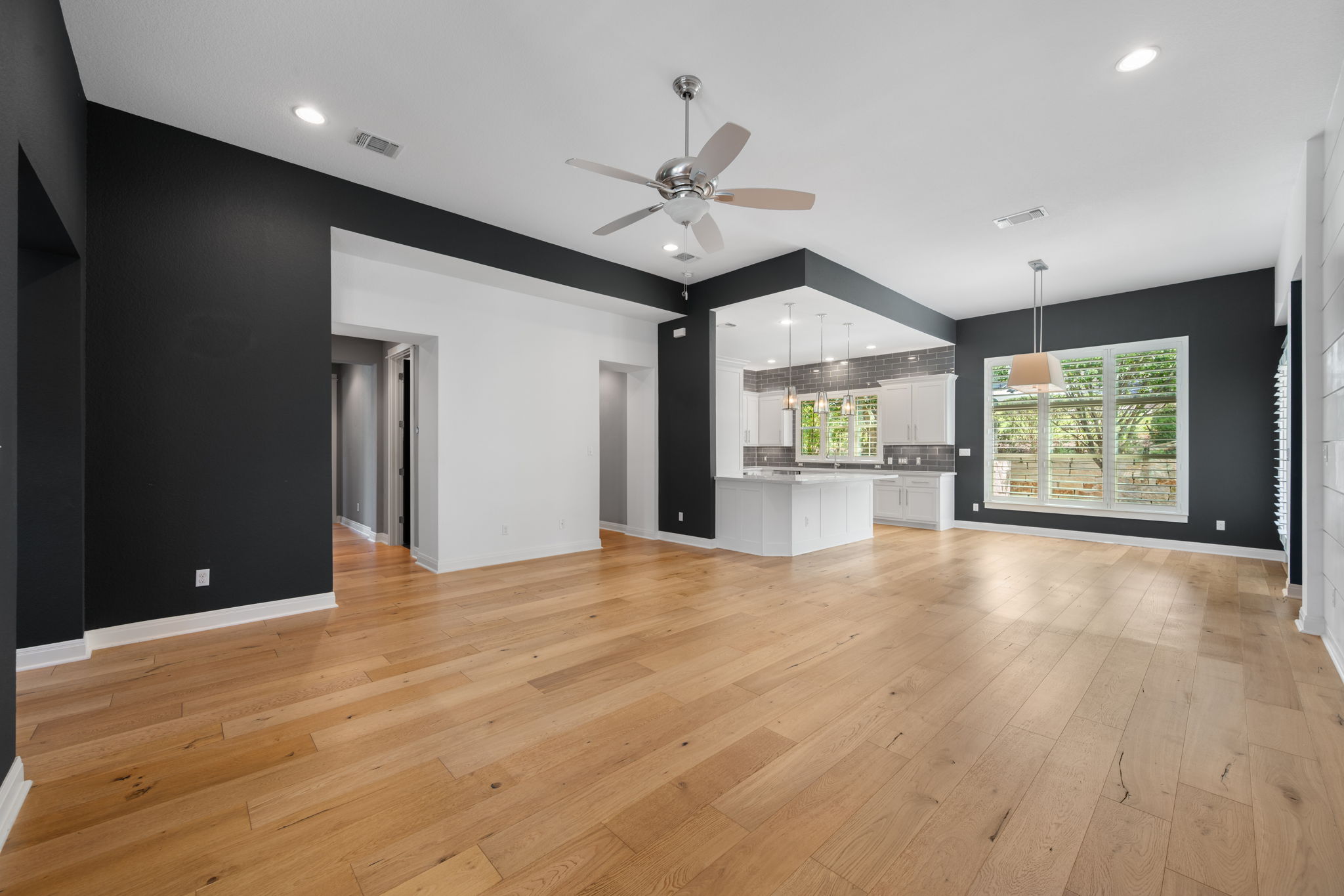 13708 Golden Wave Loop Austin, TX 78738 - Photo 11 of 34 Expansive open-concept living area featuring light-toned hardwood flooring, recessed lighting, and a ceiling fan