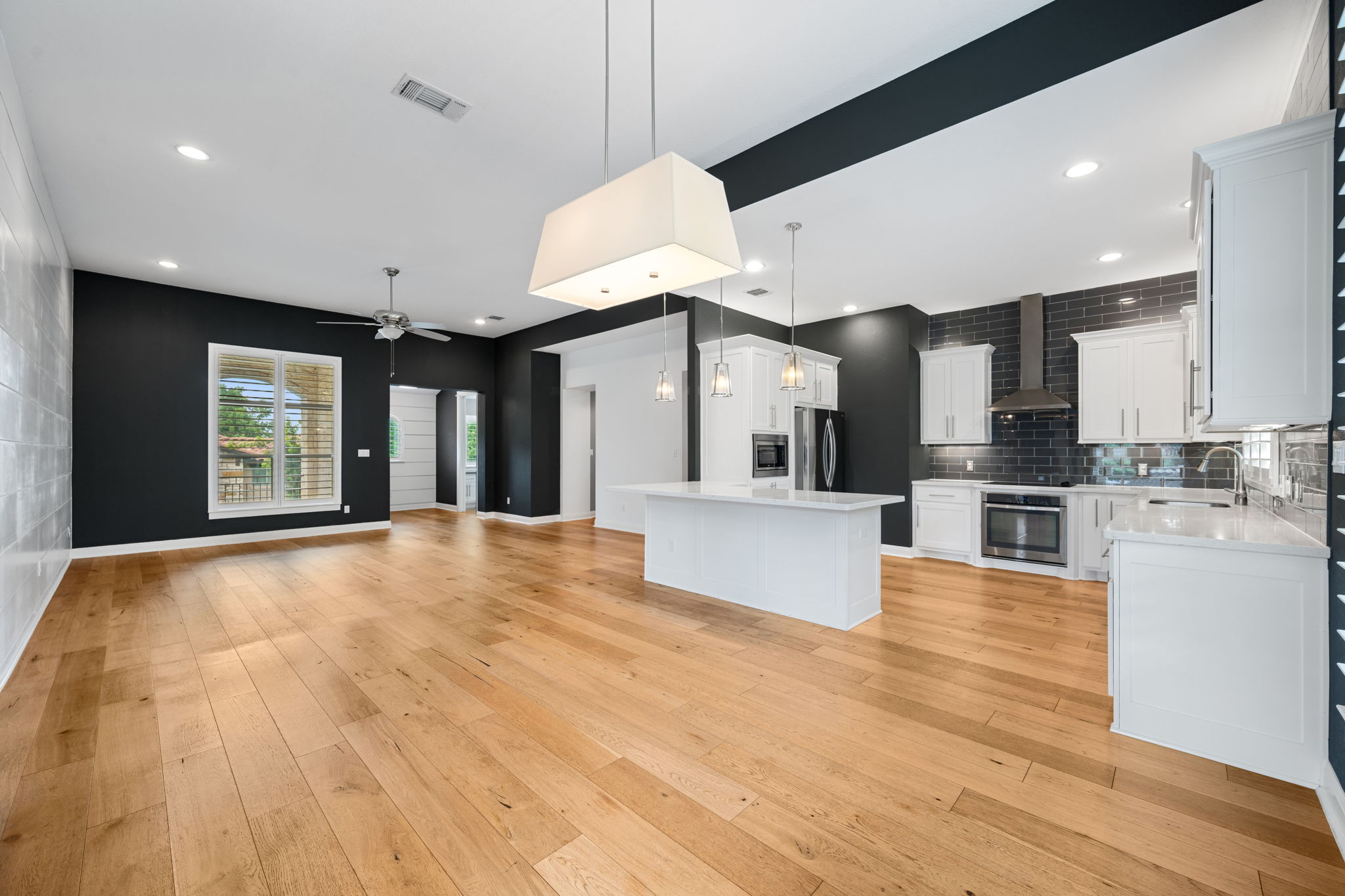 13708 Golden Wave Loop Austin, TX 78738 - Photo 15 of 34 Open concept living area featuring hardwood flooring, a ceiling fan, and recessed lighting
